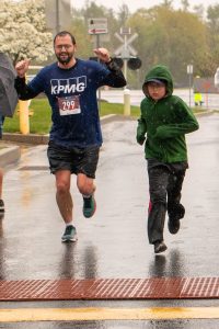 2022 Randi's Race event photo featuring runner #299 and a child